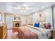 Serene main bedroom featuring a decorative fireplace, hardwood floors, and ample natural light at 142 Habersham Dr, Longwood, FL 32779