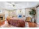 Tranquil main bedroom with wood floors, fireplace, ceiling fan and decor at 142 Habersham Dr, Longwood, FL 32779