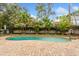 Backyard pool surrounded by mature trees and tropical foliage, creating a private and serene atmosphere at 142 Habersham Dr, Longwood, FL 32779