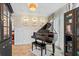 Sitting room with a piano, tiled floor, light patterned wallpaper, and sheer curtains at 142 Habersham Dr, Longwood, FL 32779