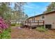 Backyard view features a deck, some flower bushes, and lush greenery, creating a serene outdoor space at 14226 Nell Dr, Orlando, FL 32832