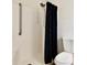 This bathroom features a shower with a dark curtain and toilet at 14226 Nell Dr, Orlando, FL 32832