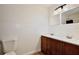 Bathroom features a wood vanity with double sinks, bead board and tile flooring at 14226 Nell Dr, Orlando, FL 32832