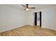 This bedroom features wood floors, neutral paint, a ceiling fan and a window at 14226 Nell Dr, Orlando, FL 32832