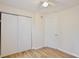 This bedroom has wood floors, neutral walls, a ceiling fan and two closets at 14226 Nell Dr, Orlando, FL 32832