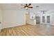 Spacious living room with wood-look floors, ceiling fan, and open access to kitchen at 14226 Nell Dr, Orlando, FL 32832