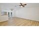 Spacious living room with wood-look floors, ceiling fan, and open access to kitchen at 14226 Nell Dr, Orlando, FL 32832