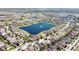 Aerial view of residential community surrounding a large lake with a fountain, and many single Gathering homes at 14434 Swanley St, Orlando, FL 32832