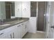 Modern bathroom featuring double vanity with gray countertop and a glass-enclosed shower at 14434 Swanley St, Orlando, FL 32832