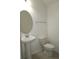 Bathroom with a pedestal sink, decorative mirror, and low-flow toilet at 14434 Swanley St, Orlando, FL 32832