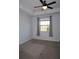 Bedroom with neutral carpet, tray ceiling with fan, and a sunlit window at 14434 Swanley St, Orlando, FL 32832