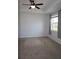 Bedroom with neutral carpet, tray ceiling with fan, and a sunlit window at 14434 Swanley St, Orlando, FL 32832