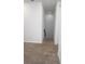 Carpeted hallway leading to a doorway and staircase, brightened by recessed lighting at 14434 Swanley St, Orlando, FL 32832