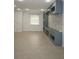 Living room with tile floors, built-in shelves, decorative brick wall, fireplace, and a window with blinds at 14434 Swanley St, Orlando, FL 32832