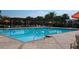 Sparkling community swimming pool with comfortable lounge seating and shaded areas for relaxation at 14434 Swanley St, Orlando, FL 32832