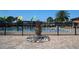 Community pool area with decorative fountain, surrounded by a black fence, perfect for relaxation at 14434 Swanley St, Orlando, FL 32832