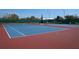 A well maintained tennis court with blue and red surface, net and several tennis balls on the court at 14434 Swanley St, Orlando, FL 32832