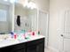 Bathroom featuring a double sink vanity with a large mirror and updated lighting at 15127 Book Club Rd, Winter Garden, FL 34787