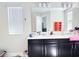 Bathroom featuring double sink vanity, large mirror and modern fixtures at 15127 Book Club Rd, Winter Garden, FL 34787