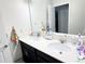 Bathroom features a large mirror, double sink vanity with quartz counters at 15127 Book Club Rd, Winter Garden, FL 34787