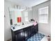 Bathroom featuring double sink vanity, large mirror and modern fixtures at 15127 Book Club Rd, Winter Garden, FL 34787