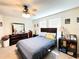 Bedroom featuring a ceiling fan, closet, bed, and dark wood furniture at 15127 Book Club Rd, Winter Garden, FL 34787