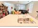 Kitchen island with sink, open to a dining area and living room with contemporary décor at 15127 Book Club Rd, Winter Garden, FL 34787