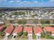 An aerial shot shows a community of homes, featuring tile roofs, backyard pools, and front-facing garages at 1520 Solana Cir, Davenport, FL 33897