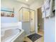 Bright bathroom showcases separate soaking tub and shower, with neutral color palette at 1520 Solana Cir, Davenport, FL 33897