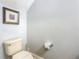 Neutral half bathroom with a tan toilet, art on the wall, and a textured wall at 1520 Solana Cir, Davenport, FL 33897