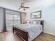 Bedroom with a large bed, a dresser, a mirror, and wood-look laminate flooring at 1520 Solana Cir, Davenport, FL 33897