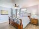 Bright bedroom with a decorative metal bed frame, hard wood floors, and natural light at 1520 Solana Cir, Davenport, FL 33897