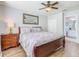 Bedroom with a large bed, a dresser, a mirror, and wood-look laminate flooring at 1520 Solana Cir, Davenport, FL 33897