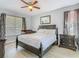 Comfortable bedroom featuring dark wood furniture, ceiling fan and a crib at 1520 Solana Cir, Davenport, FL 33897