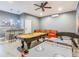 Spacious game room featuring a pool table, foosball table, air hockey, orange couch, and a wet bar at 1520 Solana Cir, Davenport, FL 33897