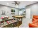 Spacious game room featuring a pool table, foosball table, air hockey, orange couch, a wet bar, and a television at 1520 Solana Cir, Davenport, FL 33897