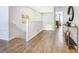 Hallway with beautiful wood flooring, white banister, and stylish console table at 1520 Solana Cir, Davenport, FL 33897