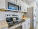 Close-up of kitchen featuring stainless steel appliances and granite countertops at 1520 Solana Cir, Davenport, FL 33897