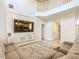 Upstairs view of the living room, featuring a decorative wall and open floor plan at 1520 Solana Cir, Davenport, FL 33897