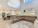 Expansive living area with a large sectional sofa and a view of the modern kitchen at 1520 Solana Cir, Davenport, FL 33897