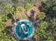 Overhead view of a community playground with slides and climbing structures surrounded by trees at 1520 Solana Cir, Davenport, FL 33897