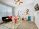 Bright and playful playroom with a colorful alphabet rug, comfortable seating, and ample natural light at 1520 Solana Cir, Davenport, FL 33897