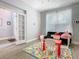 Cozy playroom featuring a bright alphabet rug, furniture, and charming decor at 1520 Solana Cir, Davenport, FL 33897