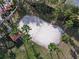 Aerial shot of a sand volleyball court surrounded by palm trees and green grass at 1520 Solana Cir, Davenport, FL 33897