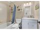 Clean bathroom with a shower-tub combo and a white vanity for daily convenience at 1716 Terry Ne Cir, Winter Haven, FL 33881