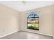 Bedroom featuring tile flooring and a beautiful view to the exterior landscape at 1716 Terry Ne Cir, Winter Haven, FL 33881