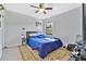 Cozy bedroom featuring a ceiling fan, a large window, and neutral-toned walls at 1716 Terry Ne Cir, Winter Haven, FL 33881