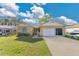 Charming home with a well-manicured lawn, two-car garage, and a convenient screened-in porch at 1716 Terry Ne Cir, Winter Haven, FL 33881