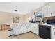 Bright kitchen featuring white cabinets and modern appliances, perfect for cooking at 1716 Terry Ne Cir, Winter Haven, FL 33881