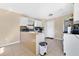 Well-lit eat-in kitchen with white cabinets, ample counter space, and durable tile flooring at 1716 Terry Ne Cir, Winter Haven, FL 33881